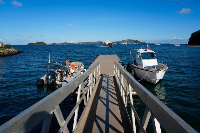 This photograph shows the newly installed temporary pontoon, after the old one was destroyed following the 2024 Cyclone Chido, in Mamoudzou, on the French Indian Ocean territory of Mayotte, on December 3, 2025. Chido, the most devastating cyclone to hit Mayotte in the last 90 years, hit France's poorest department on December 14, 2024, causing colossal damage. (Photo by Marine GACHET / AFP)