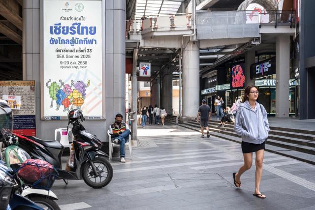 (FILES) A placard promoting Thai athletes at the 33rd SEA Games is pictured in downtown Bangkok on November 28, 2025. The Southeast Asian Games officially open in Bangkok on December 9, 2025 for thousands of athletes against a backdrop of chaotic organisation and fresh border clashes between Thailand and Cambodia threatening to overshadow the sporting showpiece. (Photo by Chanakarn Laosarakham / AFP)