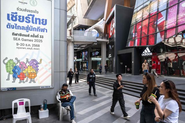 (FILES) A placard promoting Thai athletes at the 33rd SEA Games is pictured in downtown Bangkok on November 28, 2025. The Southeast Asian Games officially open in Bangkok on December 9, 2025 for thousands of athletes against a backdrop of chaotic organisation and fresh border clashes between Thailand and Cambodia threatening to overshadow the sporting showpiece. (Photo by Chanakarn Laosarakham / AFP)