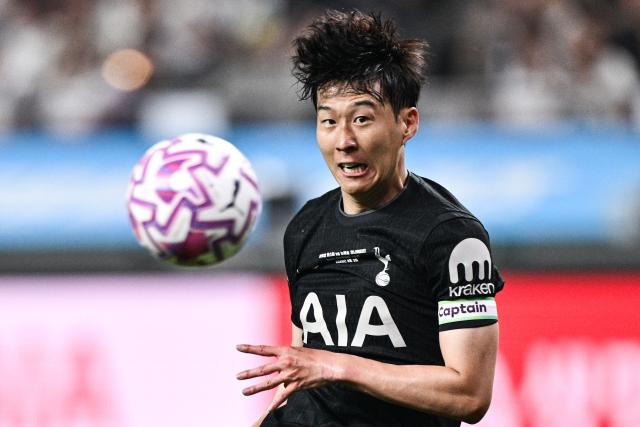 (FILES) Tottenham Hotspur's captain South Korean striker Son Heung-min eyes the ball during a friendly football match between Tottenham Hotspur and Newcastle United in Seoul on August 3, 2025. A woman who blackmailed South Korean football superstar Son Heung-min was handed a four-year jail sentence on December 8, 2025, Yonhap News TV reported. (Photo by ANTHONY WALLACE / AFP)