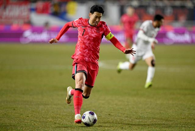 (FILES) South Korea's Son Heung-min controls the ball against Jordan during the World Cup 2026 Asian qualifier football match between South Korea and Jordan in Suwon on March 25, 2025. A woman who blackmailed South Korean football superstar Son Heung-min was handed a four-year jail sentence on December 8, 2025, Yonhap News TV reported. (Photo by Jung Yeon-je / AFP)