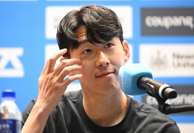 (FILES) Tottenham Hotspur's Son Heung-min reacts during a pre-match press conference in Seoul on August 2, 2025, ahead of the friendly football match between Newcastle United and Tottenham Hotspur. A woman who blackmailed South Korean football superstar Son Heung-min was handed a four-year jail sentence on December 8, 2025, Yonhap News TV reported. (Photo by Jung Yeon-je / AFP)