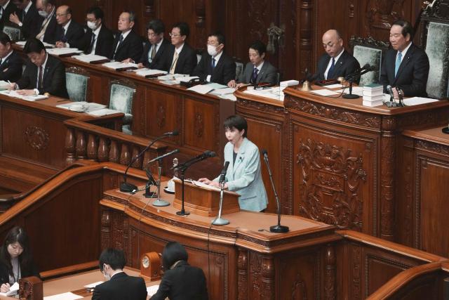 Japan's Prime Minister Sanae Takaichi (C) speaks during a plenary session of the House of Representatives at the National Diet in Tokyo on December 8, 2025. (Photo by Kazuhiro NOGI / AFP)