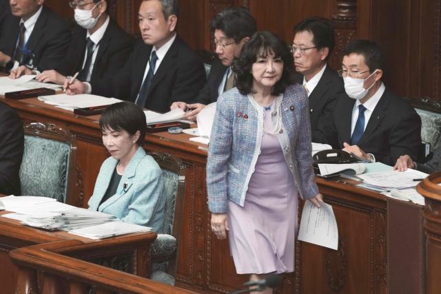 Japan's Finance Minister Satsuki Katayama (front R) heads to the podium to deliver a fiscal policy speech at the House of Representatives plenary session of the National Diet in Tokyo on December 8, 2025. (Photo by Kazuhiro NOGI / AFP)