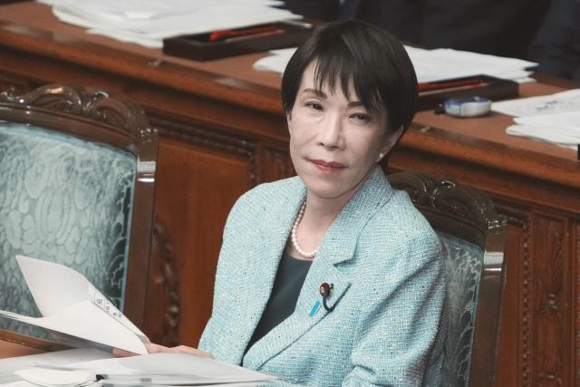 Japan's Prime Minister Sanae Takaichi listens to a question from an opposition party member during a plenary session of the House of Representatives at the National Diet in Tokyo on December 8, 2025. (Photo by Kazuhiro NOGI / AFP)