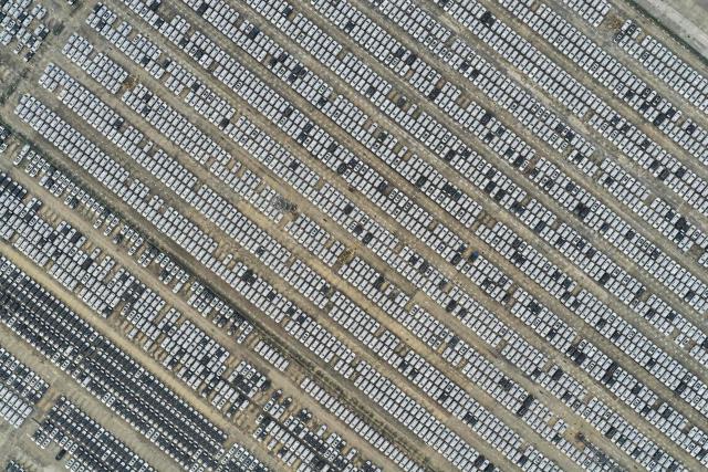 An aerial view shows vehicles awaiting to be exported at the Nanjing Port Longtan area operated by Jiangsu Port Group in Nanjing, in China's eastern Jiangsu province on December 8, 2025. (Photo by AFP) / China OUT
