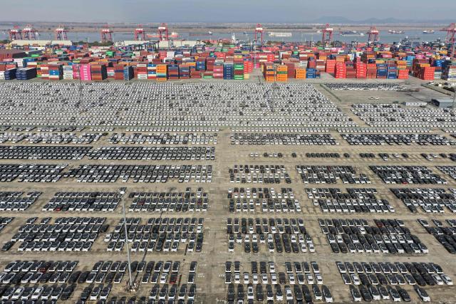 An aerial view shows vehicles awaiting to be exported at the Nanjing Port Longtan area operated by Jiangsu Port Group in Nanjing, in China's eastern Jiangsu province on December 8, 2025. (Photo by AFP) / China OUT