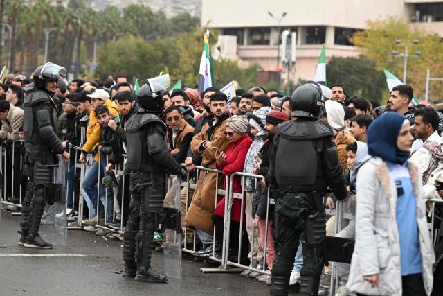 People gather to celebrate a year since the ousting of longtime ruler Bashar al-Assad in the Syrian capital Damascus on December 8, 2025. President Ahmed al-Sharaa on December 8 urged Syrians to work together to rebuild their country as they marked a year since the ousting of longtime ruler Bashar al-Assad. Sharaa's Islamist-led alliance launched a lightning offensive in late November last year, taking the capital Damascus on December 8 after nearly 14 years of war and putting an end to more than five decades of the Assad family's iron-fisted rule. (Photo by LOUAI BESHARA / AFP)