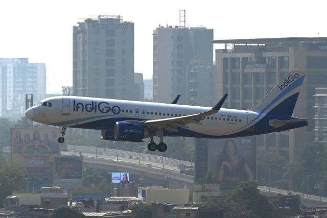 An IndiGo Airways aircraft prepares to land at the Mumbai airport on December 8, 2025. (Photo by Indranil Mukherjee / AFP)