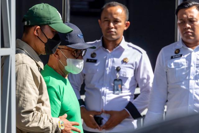 Dutch drug convict Ali Tokman(2nd L), 65, leaves Cipinang Prison in Jakarta on December 8, 2025, during his release for repatriation to the Netherlands on humanitarian grounds. Tokman, who was serving a life sentence for drug trafficking, was due to fly home later on December 8 accompanied by fellow Dutch inmate Siegfried Mets, 74,  who was sentenced to death in Indonesia 17 years ago for a similar offence and also was granted a reprieve. (Photo by ADITYA AJI / AFP)