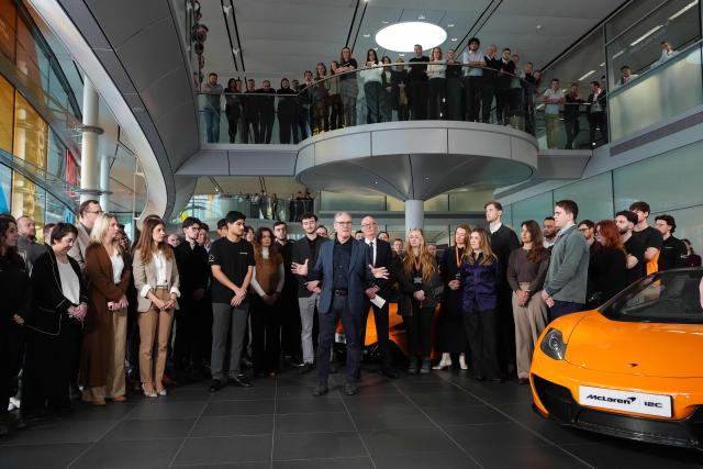 Britain's Prime Minister Keir Starmer (C) speaks during a visit to McLaren Automotive in Woking, Surrey, south-west of London, on December 8, 2025, to announce a major investment in apprenticeships in an effort to tackle rising youth unemployment. (Photo by Jonathan Brady / POOL / AFP)