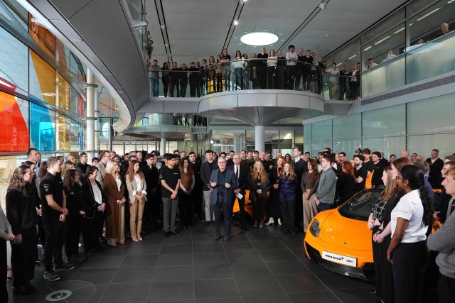 Britain's Prime Minister Keir Starmer (C) speaks during a visit to McLaren Automotive in Woking, Surrey, south-west of London, on December 8, 2025, to announce a major investment in apprenticeships in an effort to tackle rising youth unemployment. (Photo by Jonathan Brady / POOL / AFP)