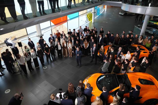 Britain's Prime Minister Keir Starmer (C) speaks during a visit to McLaren Automotive in Woking, Surrey, south-west of London, on December 8, 2025, to announce a major investment in apprenticeships in an effort to tackle rising youth unemployment. (Photo by Jonathan Brady / POOL / AFP)