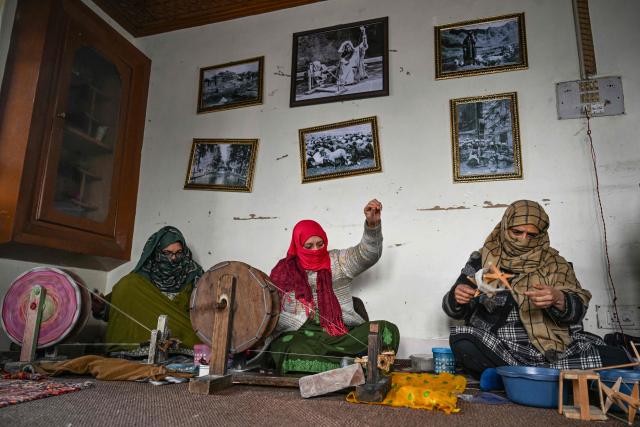 Weavers spin Pashmina yarn on a traditional handloom in Srinagar on December 8, 2025. (Photo by Tauseef MUSTAFA / AFP)