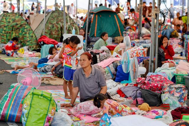 Evacuated Thai residents gather at a temporary shelter following clashes along the Thailand-Cambodia border in Buriram province on December 8, 2025. Thailand launched air strikes on its neighbour Cambodia on December 8, the Thai army said, with both sides trading blame for the latest eruption of fighting on their disputed border which killed a Thai soldier. (Photo by Sarot Meksophawannakul / THAI NEWS PIX / AFP)
