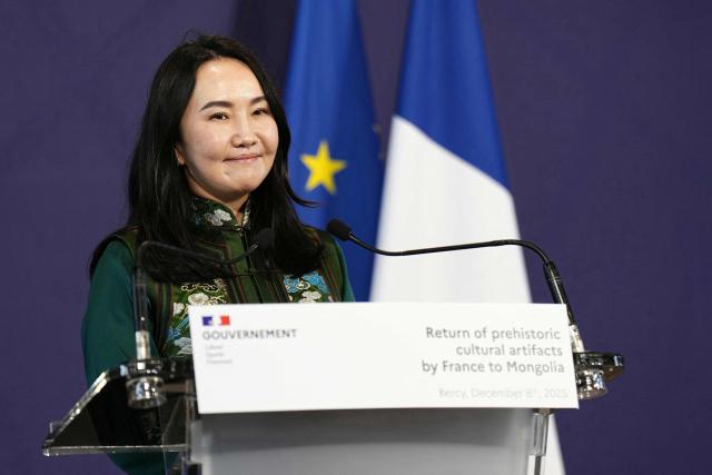 Minister of Culture, Sports, Tourism and Youth of Mongolia Undram Chinbat, next to France's Public Accounts Minister (not pictured), holds a press conference during the handover of prehistoric cultural artifacts to Mongolian authorities at the Ministry of the Economy and Finance building (Bercy), in Paris on December 8, 2025. (Photo by Dimitar DILKOFF / AFP)