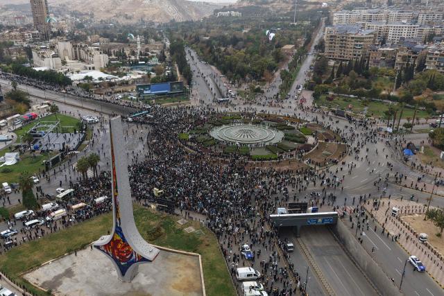 An areal photograph shows people celebrating a year since the ousting of longtime ruler Bashar al-Assad in the Syrian capital Damascus on December 8, 2025. President Ahmed al-Sharaa on December 8 urged Syrians to work together to rebuild their country as they marked a year since the ousting of longtime ruler Bashar al-Assad. Sharaa's Islamist-led alliance launched a lightning offensive in late November last year, taking the capital Damascus on December 8 after nearly 14 years of war and putting an end to more than five decades of the Assad family's iron-fisted rule. (Photo by Bakr ALKASEM / AFP)