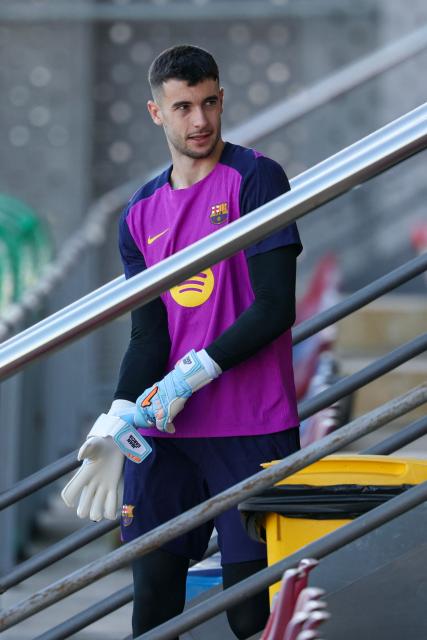 Barcelona's Spanish goalkeeper #13 Joan Garcia arrives for a training session on the eve of the UEFA Champions League league phase day 6 football match between FC Barcelona and Eintracht Frankfurt at the Joan Gamper training ground in Sant Joan Despi, near Barcelona, on December 8, 2025. (Photo by Lluis GENE / AFP)