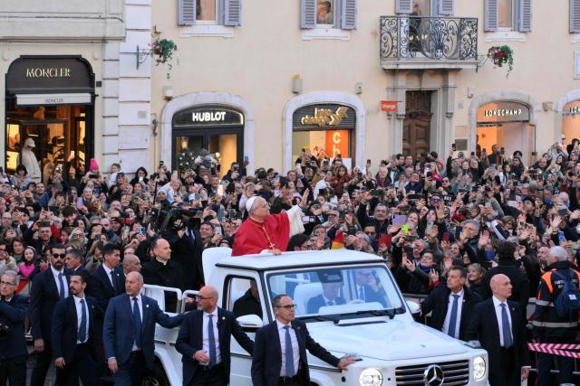 Pope Leo XIV waves to the crowd from the popemobile as he arrives to pay homage to the Immaculate Conception, near the Spanish steps in Rome, on December 8, 2025. (Photo by Tiziana FABI / AFP)