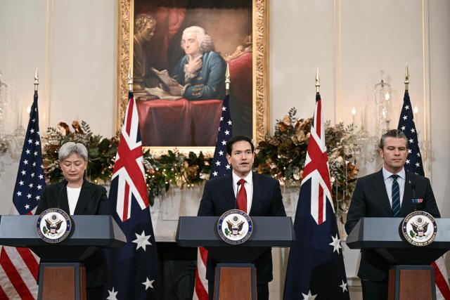 (L/R) Australian Foreign Minister Penny Wong, US Secretary of State Marco Rubio, and US Secretary of Defense Pete Hegseth deliver remarks during the 35th Australia-US Ministerial Consultations (AUSMIN) at the State Department in Washington, DC, on December 8, 2025. (Photo by Brendan SMIALOWSKI / AFP)