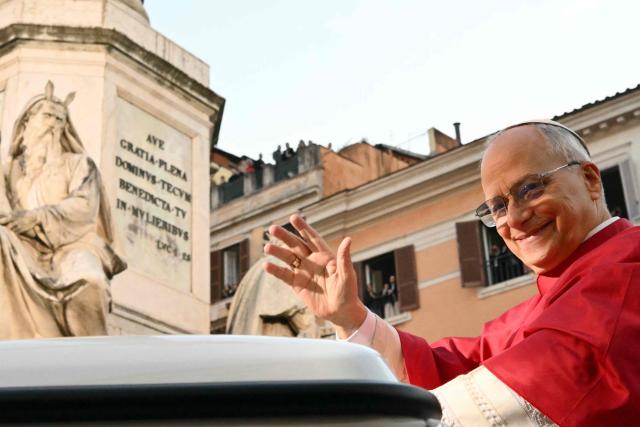 Pope Leo XIV waves to the crowd from the popemobile as he leaves after paying homage to the Immaculate Conception, near the Spanish steps in Rome, on December 8, 2025. (Photo by Alberto PIZZOLI / AFP)