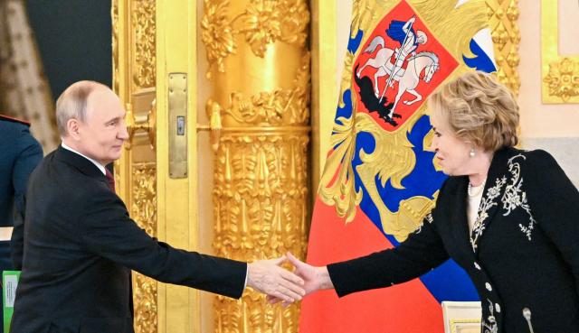 In this pool photograph distributed by the Russian state agency Sputnik, Russia's President Vladimir Putin shakes hands with Federation Council speaker Valentina Matviyenko during a meeting of the Council for Strategic Development and National Projects at the Kremlin in Moscow on December 8, 2025. (Photo by Kristina Kormilitsyna / POOL / AFP)