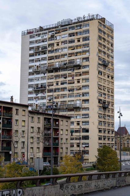 (FILES) This photograph shows a view of The Bel Horizon tower located in the 3rd arrondissement of Marseille, on December 3, 2025. In the poorest major city in France, drug-related murders no longer necessarily occur at night, away from prying eyes. Of the 17 that have taken place since January, five occurred during the day, on busy streets, in front of helpless witnesses, according to an AFP tally. In the lobby of the Bel Horizon tower in Marseille, the phone number of the Avad association (Aid for victims of criminal acts) is posted after the death in late November of a young man, riddled with bullets at a drug dealing spot at the building's entrance, who came to seek refuge in its upper floors. (Photo by Miguel MEDINA / AFP)