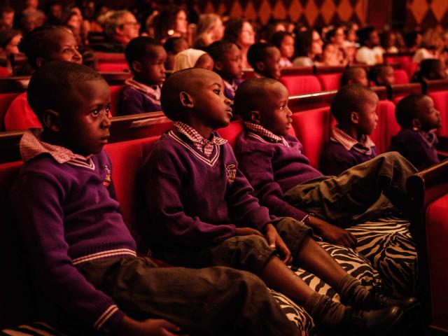 Students watch as members of Dance Centre Kenya (DCK) perform in their 10th-anniversary annual ballet production, The Nutcracker, with the DCK Orchestra at the Kenya National Theatre in Nairobi on December 6, 2025. Dance Centre Kenya (DCK) is one of East Africas leading performing arts schools, training hundreds of students each year in ballet, contemporary, and other dance forms, and provides opportunities for talented young dancers from diverse socioeconomic backgrounds to perform in major productions like The Nutcracker. (Photo by YASUYOSHI CHIBA / STF / AFP)