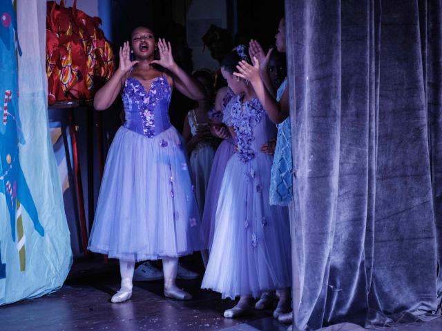 Members of Dance Centre Kenya (DCK) encourage the dancers on stage from the wings during their 10th-anniversary annual ballet production, The Nutcracker, with the DCK Orchestra at the Kenya National Theatre in Nairobi on December 6, 2025. Dance Centre Kenya (DCK) is one of East Africas leading performing arts schools, training hundreds of students each year in ballet, contemporary, and other dance forms, and provides opportunities for talented young dancers from diverse socioeconomic backgrounds to perform in major productions like The Nutcracker. (Photo by YASUYOSHI CHIBA / STF / AFP)