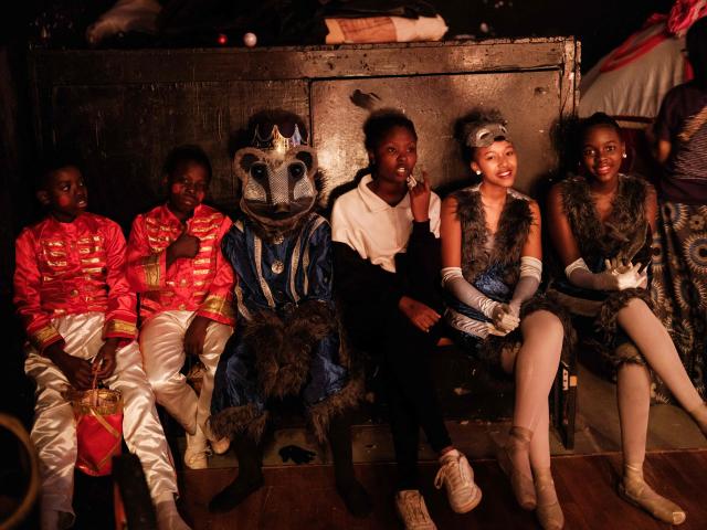 Members of Dance Centre Kenya (DCK) wait in the wings before performing during their 10th-anniversary annual ballet production, The Nutcracker, with the DCK Orchestra at the Kenya National Theatre in Nairobi on December 6, 2025. Dance Centre Kenya (DCK) is one of East Africas leading performing arts schools, training hundreds of students each year in ballet, contemporary, and other dance forms, and provides opportunities for talented young dancers from diverse socioeconomic backgrounds to perform in major productions like The Nutcracker. (Photo by YASUYOSHI CHIBA / STF / AFP)