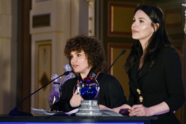 Oksana Nechyporenko (L) and Mariia Yefrosinina, founders of the Ukrainian Masha Foundation, deliver a speech after receiving the International Gender Equality Prize at the prize ceremony in Tampere, Finland, on December 8, 2025. The Masha Foundation is a Ukrainian public organisation which carries out significant work to help Ukrainian women overcome the psychological consequences of war and other violence. Finland awarded the International Gender Equality Prize for the fifth time. (Photo by Antti Aimo-Koivisto / Lehtikuva / AFP) / Finland OUT