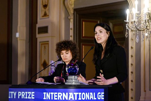 Oksana Nechyporenko (L) and Mariia Yefrosinina, founders of the Ukrainian Masha Foundation, deliver a speech after receiving the International Gender Equality Prize at the prize ceremony in Tampere, Finland, on December 8, 2025. The Masha Foundation is a Ukrainian public organisation which carries out significant work to help Ukrainian women overcome the psychological consequences of war and other violence. Finland awarded the International Gender Equality Prize for the fifth time. (Photo by Antti Aimo-Koivisto / Lehtikuva / AFP) / Finland OUT