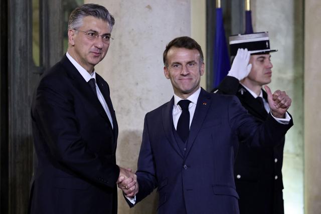 France's President Emmanuel Macron (R) welcomes Croatia's Prime Minister Andrej Plenkovic prior to a meeting at the Elysee Palace in Paris, on December 8, 2025. (Photo by Anne-Christine POUJOULAT / AFP)