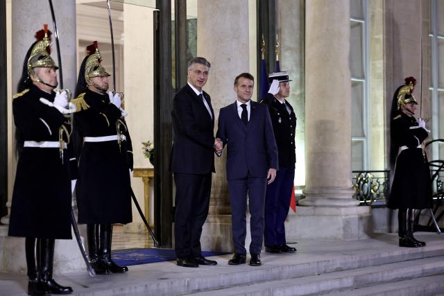 France's President Emmanuel Macron (C-R) welcomes Croatia's Prime Minister Andrej Plenkovic (C-R) prior to a meeting at the Elysee Palace in Paris, on December 8, 2025. (Photo by Anne-Christine POUJOULAT / AFP)