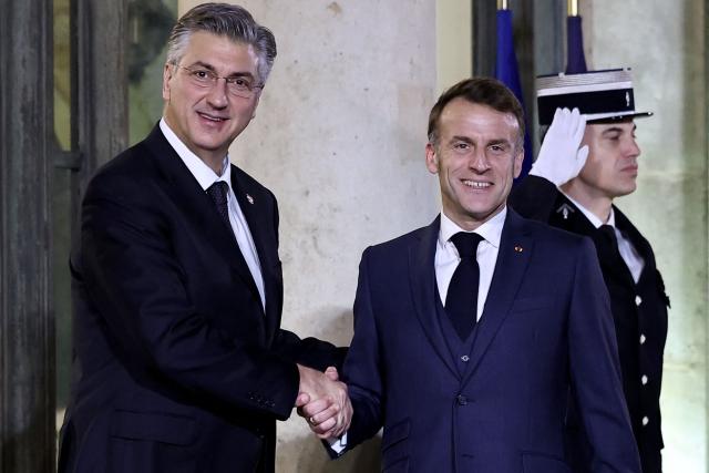 France's President Emmanuel Macron (C) welcomes Croatia's Prime Minister Andrej Plenkovic prior to a meeting at the Elysee Palace in Paris, on December 8, 2025. (Photo by Anne-Christine POUJOULAT / AFP)