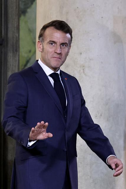 France's President Emmanuel Macron waves as he arrives to welcome Croatian Prime Minister at the Elysee Palace in Paris, on December 8, 2025. (Photo by Anne-Christine POUJOULAT / AFP)