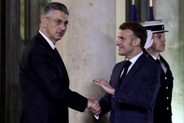 France's President Emmanuel Macron (C) welcomes Croatia's Prime Minister Andrej Plenkovic prior to a meeting at the Elysee Palace in Paris, on December 8, 2025. (Photo by Anne-Christine POUJOULAT / AFP)