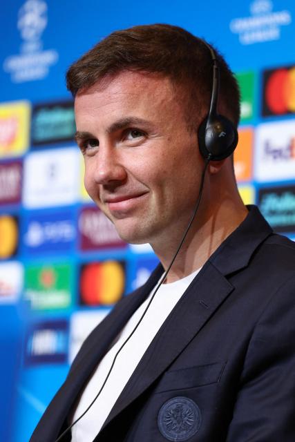 Frankfurt's German midfielder #27 Mario Goetze smiles during a press conference on the eve of the UEFA Champions League league phase day 6 football match between FC Barcelona and Eintracht Frankfurt at Camp Nou Stadium in Barcelona on December 8, 2025. (Photo by Josep LAGO / AFP)