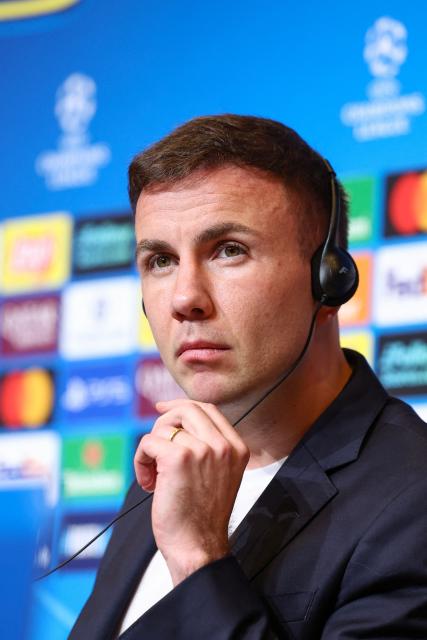 Frankfurt's German midfielder #27 Mario Goetze listens during a press conference on the eve of the UEFA Champions League league phase day 6 football match between FC Barcelona and Eintracht Frankfurt at Camp Nou Stadium in Barcelona on December 8, 2025. (Photo by Josep LAGO / AFP)