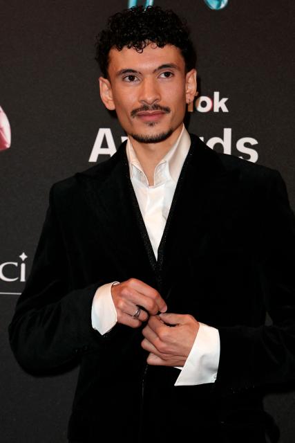 TikToker known as "sarkodamelio" poses during the photocall before the third edition of the Tiktok Awards ceremony at the Lido cabaret, in Paris on December 8, 2025. (Photo by Thomas SAMSON / AFP)