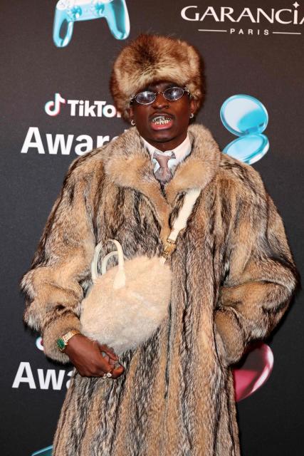 TikToker known as "Maconga20" poses during the photocall before the third edition of the Tiktok Awards ceremony at the Lido cabaret, in Paris on December 8, 2025. (Photo by Thomas SAMSON / AFP)