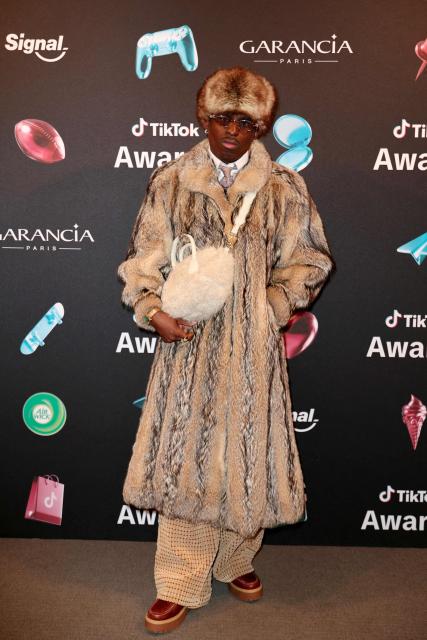 TikToker known as "Maconga20" poses during the photocall before the third edition of the Tiktok Awards ceremony at the Lido cabaret, in Paris on December 8, 2025. (Photo by Thomas SAMSON / AFP)