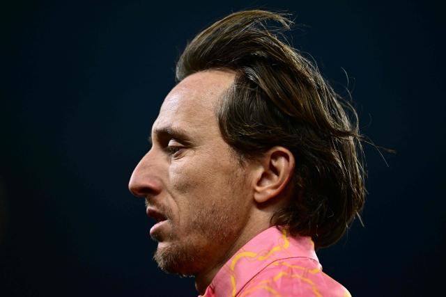 AC Milan's Croatian midfielder #14 Luka Modric warms up before the Italian Serie A football match between Torino and AC Milan at the Allianz stadium in Turin, on December 8, 2025. (Photo by Marco BERTORELLO / AFP)