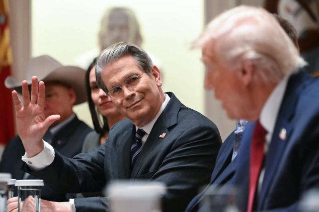 (L/R) US Secretary of Treasury Scott Bessent gestures as US President Donald Trump speaks in a roundtable event to discuss aid for farmers, in the Cabinet Room of the White House in Washington, DC, on December 8, 2025. President Trump is announcing a $12 billion aid package for US farmers, targeting a key support base hit by his trade policies. Since Trump's return to the White House in January, many US farmers have been battered by impacts of his wide-ranging tariffs, including retaliatory measures from trading partners. (Photo by ANDREW CABALLERO-REYNOLDS / AFP)