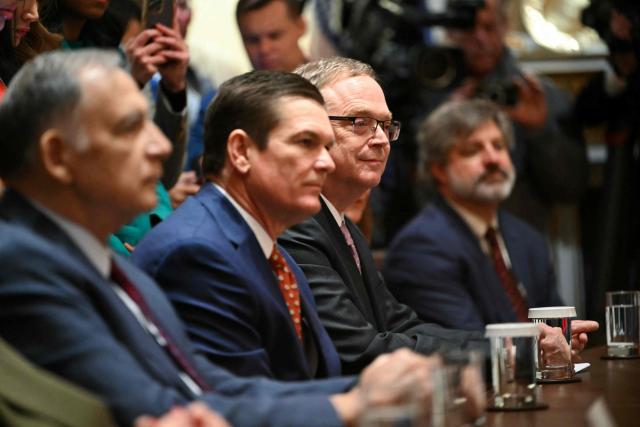 Director of the National Economic Council (3R) Kevin Hassett  listens as US President Donald Trump holds a roundtable event to discuss aid for farmers, in the Cabinet Room of the White House in Washington, DC, on December 8, 2025. President Trump is announcing a $12 billion aid package for US farmers, targeting a key support base hit by his trade policies. Since Trump's return to the White House in January, many US farmers have been battered by impacts of his wide-ranging tariffs, including retaliatory measures from trading partners. (Photo by ANDREW CABALLERO-REYNOLDS / AFP)