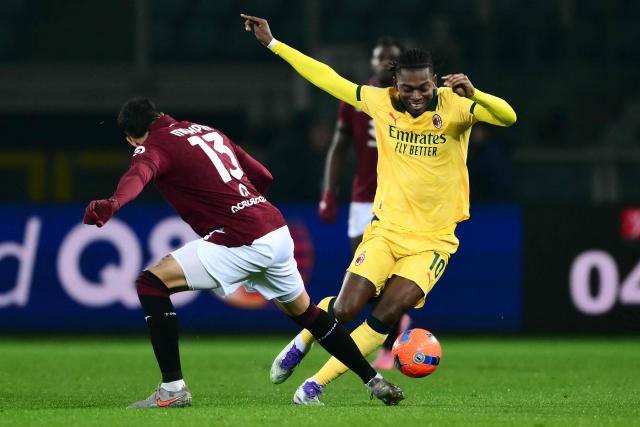 AC Milan's Portuguese forward #10 Rafael Leao fights for the ball with Torino's Chilean defender #13 Guillermo Maripan during the Italian Serie A football match between Torino and AC Milan at the Allianz stadium in Turin, on December 8, 2025. (Photo by Marco BERTORELLO / AFP)