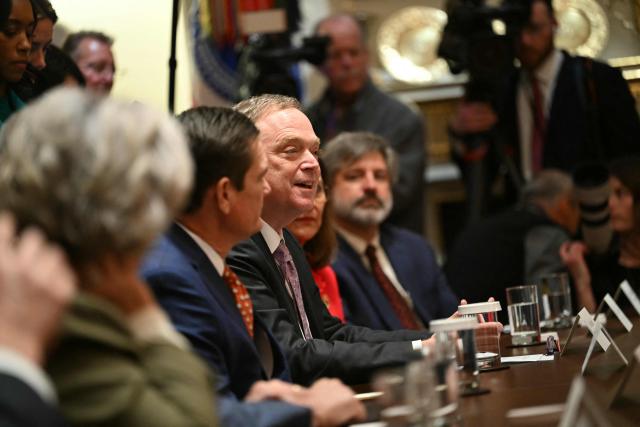 Director of the National Economic Council, Kevin Hassett (C) speaks during a roundtable event hosted by US President Donald Trump to discuss aid for farmers, in the Cabinet Room of the White House in Washington, DC, on December 8, 2025. President Trump is announcing a $12 billion aid package for US farmers, targeting a key support base hit by his trade policies. Since Trump's return to the White House in January, many US farmers have been battered by impacts of his wide-ranging tariffs, including retaliatory measures from trading partners. (Photo by ANDREW CABALLERO-REYNOLDS / AFP)