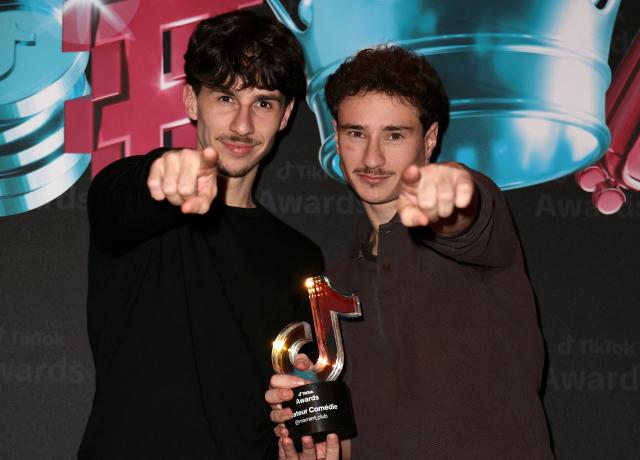 TikTokers known as "marrant club" pose after receiving the Comedy Creator of the Year award during the third edition of the Tiktok Awards ceremony at the Lido cabaret, in Paris on December 8, 2025. (Photo by Thomas SAMSON / AFP)