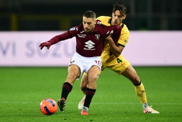 Torino's Croatian midfielder #10 Nikola Vlasic fights for the ball with AC Milan's Italian midfielder #04 Samuele Ricci during the Italian Serie A football match between Torino and AC Milan at the Allianz stadium in Turin, on December 8, 2025. (Photo by Marco BERTORELLO / AFP)