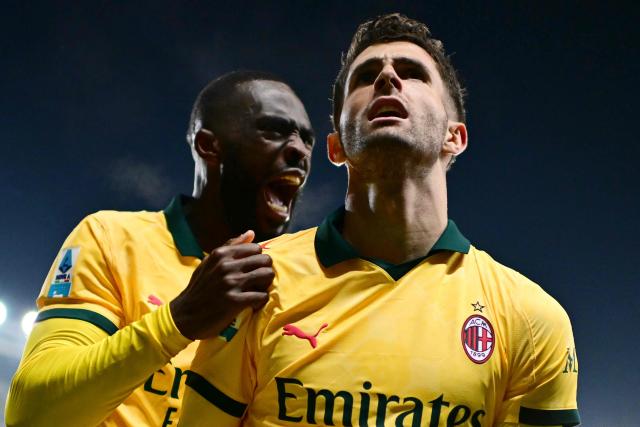 AC Milan's US forward #11 Christian Pulisic celebrates with AC Milan's English defender #23 Fikayo Tomori after scoring his team's third goal during the Italian Serie A football match between Torino and AC Milan at the Allianz stadium in Turin, on December 8, 2025. (Photo by Marco BERTORELLO / AFP)